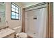 Charming bathroom features white shiplap walls, a tiled shower, and a toilet under a window at 2855 Se 38Th St, Ocala, FL 34480