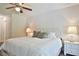 Bright bedroom featuring a bed with decorative pillows, bedside tables, and soft lighting at 2855 Se 38Th St, Ocala, FL 34480