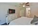 Bedroom with dresser and TV near bed, doorway to bathroom at 2855 Se 38Th St, Ocala, FL 34480
