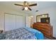 Bedroom showcasing a large dresser with mirror, closet, and a comfortable bed with blue accents at 2855 Se 38Th St, Ocala, FL 34480