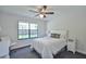 Cozy bedroom with ample natural light, ceiling fan, and plush carpeting at 2855 Se 38Th St, Ocala, FL 34480