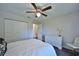 Bright bedroom with ceiling fan, closet, dresser, and comfortable carpet flooring at 2855 Se 38Th St, Ocala, FL 34480