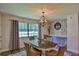 Cozy dining area featuring a chandelier, large window for natural light, and stylish decor at 2855 Se 38Th St, Ocala, FL 34480