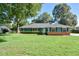 Charming single-story home with a well-manicured lawn, mature trees, and appealing blue exterior at 2855 Se 38Th St, Ocala, FL 34480