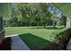 Expansive front yard with lush green grass, mature trees, and tidy landscaping offering curb appeal at 2855 Se 38Th St, Ocala, FL 34480