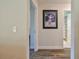 Hallway showcasing framed wall art and providing views into other rooms at 2855 Se 38Th St, Ocala, FL 34480