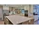 Bright kitchen featuring a spacious island, stainless steel appliances, and wooden shelving at 2855 Se 38Th St, Ocala, FL 34480