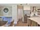 Modern kitchen with stainless steel refrigerator, white cabinets, and a dining area with neutral furniture at 2855 Se 38Th St, Ocala, FL 34480