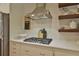 Close-up of stainless steel range hood, cooktop, and butcher block on the countertop at 2855 Se 38Th St, Ocala, FL 34480