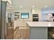 Modern kitchen featuring white cabinets, quartz countertops, stainless appliances, and open shelving at 2855 Se 38Th St, Ocala, FL 34480