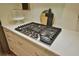 Close-up of modern stovetop with stainless steel finishes and granite countertops at 2855 Se 38Th St, Ocala, FL 34480