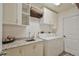 Functional laundry room with sink, counter, cabinets, and included washer/dryer at 2855 Se 38Th St, Ocala, FL 34480