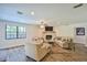 Inviting living room showcasing a brick fireplace, wood floors, and abundant natural light at 2855 Se 38Th St, Ocala, FL 34480