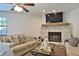 Comfortable living room with brick fireplace, mounted TV, and neutral furniture at 2855 Se 38Th St, Ocala, FL 34480