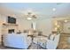 Bright living room features white brick fireplace, ceiling fan, and wood-look flooring at 2855 Se 38Th St, Ocala, FL 34480