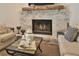 Living room showcasing a brick fireplace with wood mantle and comfortable seating at 2855 Se 38Th St, Ocala, FL 34480