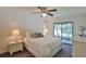Main bedroom features a large bed, sliding glass doors, and well-lit nightstands with lamps at 2855 Se 38Th St, Ocala, FL 34480