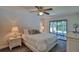 Main bedroom features a large bed, sliding glass doors, and well-lit nightstands with lamps at 2855 Se 38Th St, Ocala, FL 34480