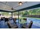 Covered patio with seating area, ceiling fan, and view of the pool and backyard at 2855 Se 38Th St, Ocala, FL 34480