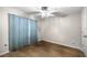 Empty bedroom featuring hardwood floor, fan, window and curtains at 329 Larch Rd, Ocala, FL 34480