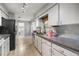 Traditional kitchen with white cabinets, black appliances and tile floor at 329 Larch Rd, Ocala, FL 34480