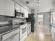 Functional kitchen with white cabinetry, black appliances and ample counter space at 329 Larch Rd, Ocala, FL 34480