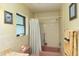 Cozy bathroom with neutral tile, a pink tub, shower, window, and matching fixtures at 3427 Se 137Th St, Summerfield, FL 34491