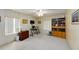 Carpeted bedroom with ceiling fan, windows, decorative wall art, and wooden shelving at 3427 Se 137Th St, Summerfield, FL 34491