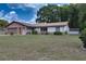 Lovely one-story house displaying a stone facade, attached garage, and manicured landscaping at 3427 Se 137Th St, Summerfield, FL 34491