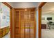 Hallway view of bathroom and den; features include closet with louvered doors and neutral paint at 3427 Se 137Th St, Summerfield, FL 34491