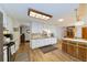 Open kitchen with laminate floors, white cabinetry, wood countertops, and bright lighting at 3427 Se 137Th St, Summerfield, FL 34491