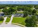 Aerial view of the home with a long driveway and a sprawling green lawn at 3883 Se 51St Ct, Ocala, FL 34480