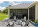 Relaxing backyard oasis with screened patio, fire pit, and lush landscaping offering privacy at 3883 Se 51St Ct, Ocala, FL 34480