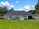 Expansive backyard featuring a well-manicured lawn and a charming screened-in patio for outdoor living at 3883 Se 51St Ct, Ocala, FL 34480