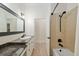 Bathroom showcasing tiled shower, tub, vanity with granite countertop and dark fixtures at 3883 Se 51St Ct, Ocala, FL 34480