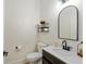 Powder room featuring a modern sink, black hardware, and updated fixtures at 3883 Se 51St Ct, Ocala, FL 34480