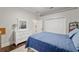 Well-lit bedroom with blue bedding, wood floors, white dresser, and spacious closet at 3883 Se 51St Ct, Ocala, FL 34480