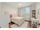 Cozy bedroom with a large window and natural light; features a ceiling fan at 3883 Se 51St Ct, Ocala, FL 34480