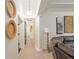 Hallway featuring a decorative column, tile floors, and a view into another room at 3883 Se 51St Ct, Ocala, FL 34480