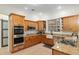Modern kitchen with stainless steel appliances, double ovens, gas cooktop, and granite countertops at 3883 Se 51St Ct, Ocala, FL 34480