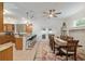 Open layout with kitchen island, breakfast bar, and adjacent dining area with large table at 3883 Se 51St Ct, Ocala, FL 34480