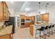 Well-equipped kitchen featuring custom cabinets, granite countertops, a breakfast bar, and stainless appliances at 3883 Se 51St Ct, Ocala, FL 34480