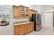 Kitchen featuring wooden cabinets, granite countertops, and stainless steel refrigerator at 3883 Se 51St Ct, Ocala, FL 34480