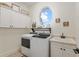 Bright laundry room with modern washer and dryer and plenty of cabinet space at 3883 Se 51St Ct, Ocala, FL 34480