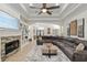 Open-concept living room featuring a large sectional, fireplace, and view of the entryway at 3883 Se 51St Ct, Ocala, FL 34480