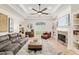 Bright living room with tile flooring, built-in bookshelves, and a cozy fireplace at 3883 Se 51St Ct, Ocala, FL 34480