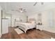 Spacious main bedroom with tray ceiling, wood floors, and stylish decor with a decorative wrought iron motif at 3883 Se 51St Ct, Ocala, FL 34480