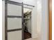 Large walk-in pantry with frosted glass barn door, shelving, and wood flooring at 3883 Se 51St Ct, Ocala, FL 34480