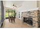 Screened porch featuring a stone fireplace and outdoor dining area, and backyard view at 3883 Se 51St Ct, Ocala, FL 34480