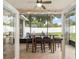 Screened porch with tiled floors, a ceiling fan, and outdoor furniture at 3883 Se 51St Ct, Ocala, FL 34480